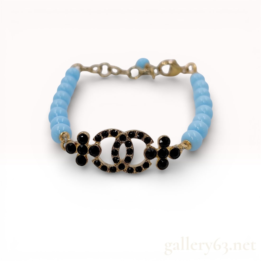 Chanel C23A Resin Beaded Black Rhinestone Logo Bracelet with Box 7": Authentic Chanel CC logo bracelet featuring light blue resin beads and a gold-tone CC logo embellished with black rhinestones. Excellent Condition