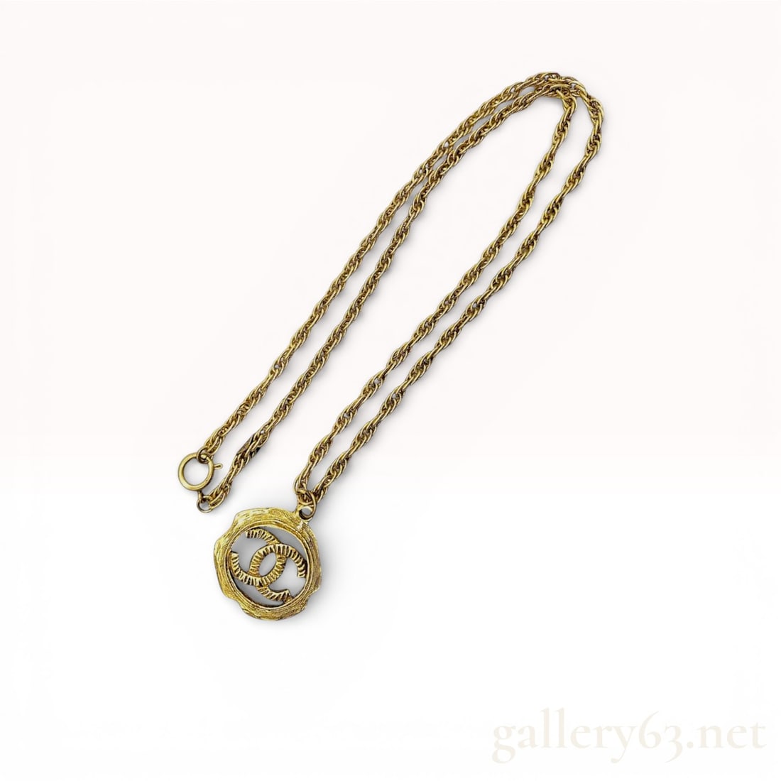 Chanel CC Circle Gold Vintage Necklace: Authentic vintage Chanel CC gold-plated rope chain necklace with a spring ring clasp closure. Pre 1980s circular plaque. Est. age on this piece is 1971-1980. Online for around $2500. 