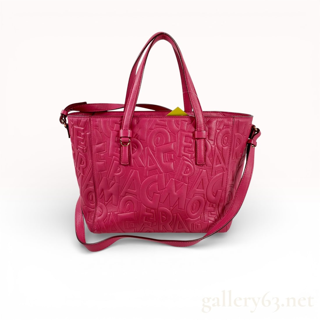 Salvatore Ferragamo Bonnie 2WAY handbag in dark pink embossed leather: Authentic Salvatore Ferragamo Bonnie 2WAY handbag in dark pink embossed leather featuring raised Ferragamo letter design across exterior; structured rectangular shape with dual top handles and detacha