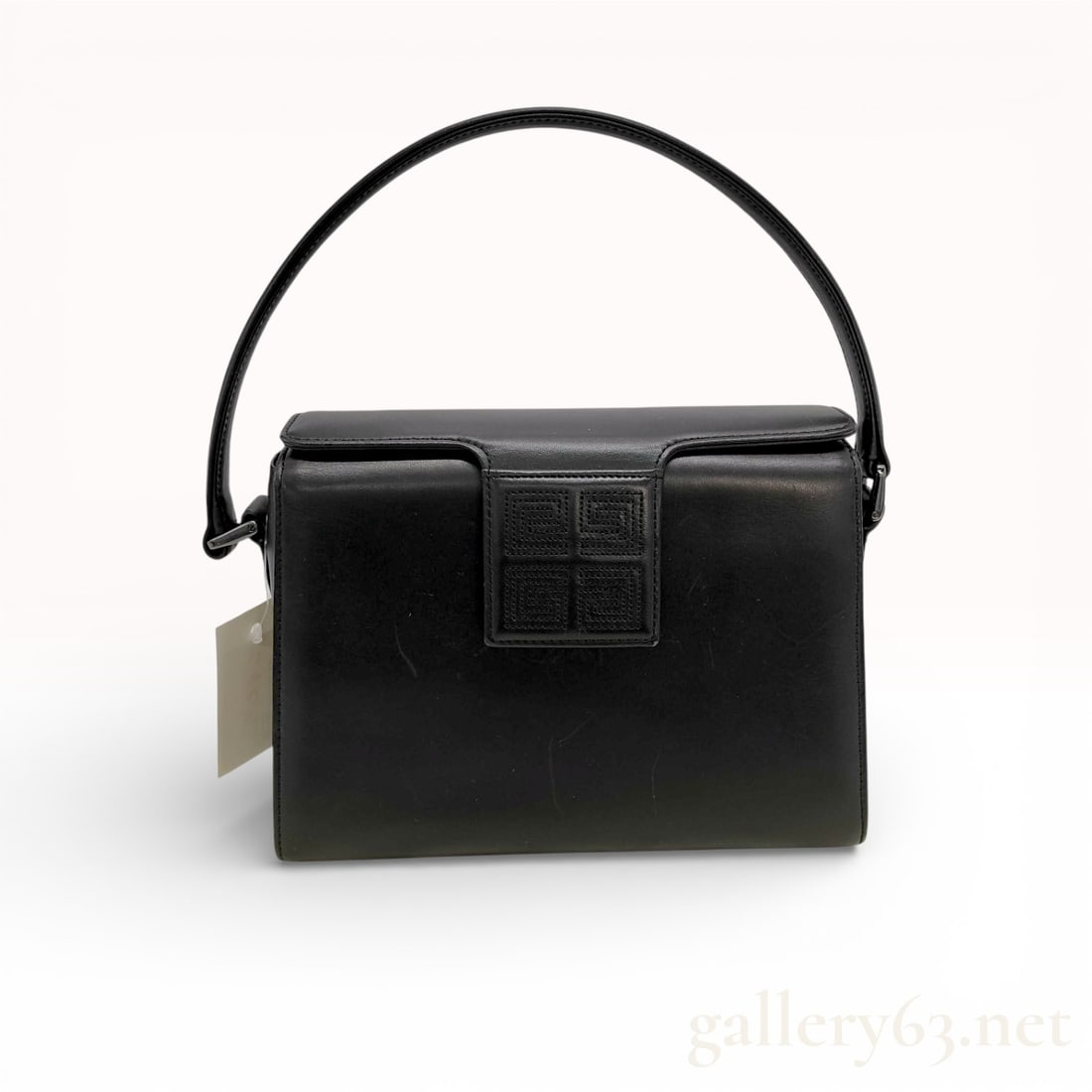 Givenchy Black Leather Top Handle Handbag with Logo Panel and Structured Silhouette: Givenchy handbag crafted in black smooth leather featuring a structured rectangular silhouette. Designed with a single top handle and flap-style front with embossed Givenchy logo panel detail. Reinfor