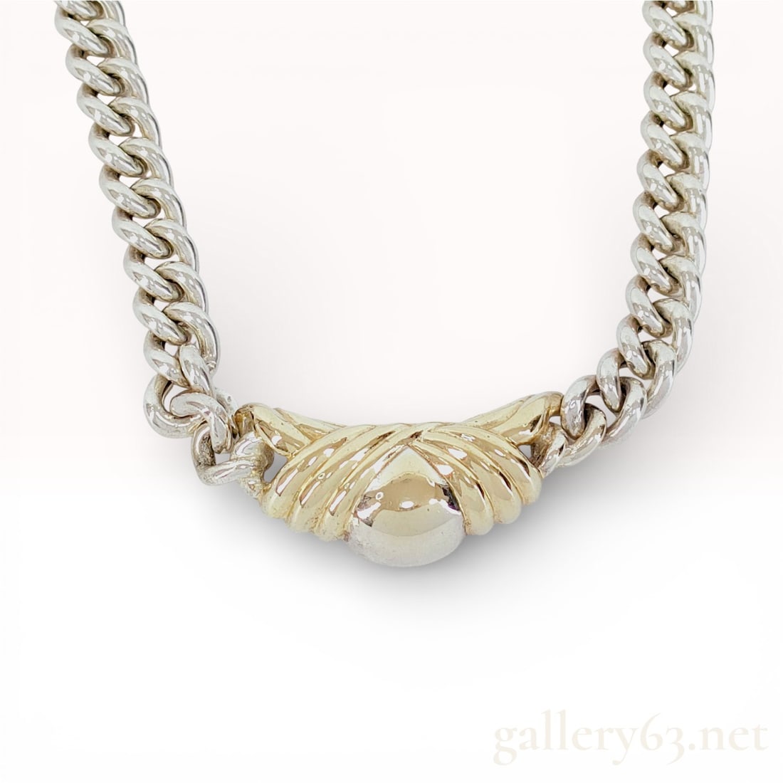 Dior Sterling Silver Curb Chain Necklace with Gold-Plated Sculptural Center: Dior necklace crafted in sterling silver featuring a substantial curb link chain. Centerpiece designed with a sculptural gold-plated element in a fan-like motif, accented by a polished domed detail at