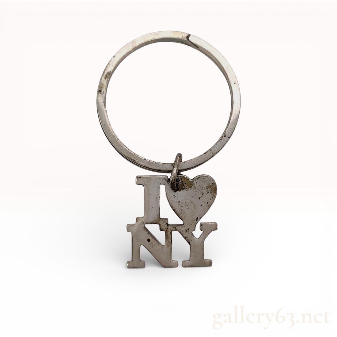 Vintage Tiffany & Co. I Love NY Sterling Silver Key Ring Keychain: Vintage Tiffany & Co. key ring keychain featuring a sterling silver circular ring. Hanging charm having an “I ? NY” motif in cutout letter form with a small heart accent.