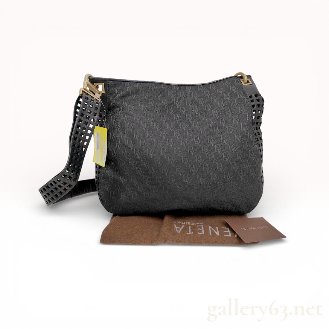 Bottega Veneta Perforated BV Pattern Black Shoulder Bag with Wide Strap: Bottega Veneta shoulder bag crafted in black leather featuring an allover perforated BV monogram pattern. Designed with a wide perforated shoulder strap and gold-tone hardware. Soft curved silhouette