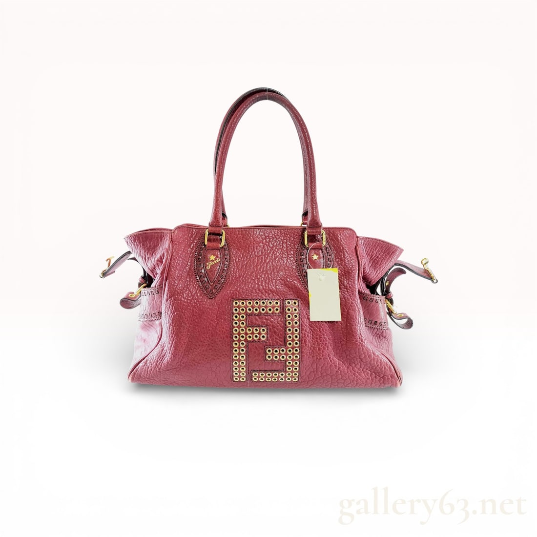 Fendi Etnico Bordeaux Leather Shoulder Bag: Authentic Fendi Etnico shoulder bag in bordeaux grained leather, featuring a softly structured silhouette with winged side panels and decorative leather trim. The front is detailed with a large FF log