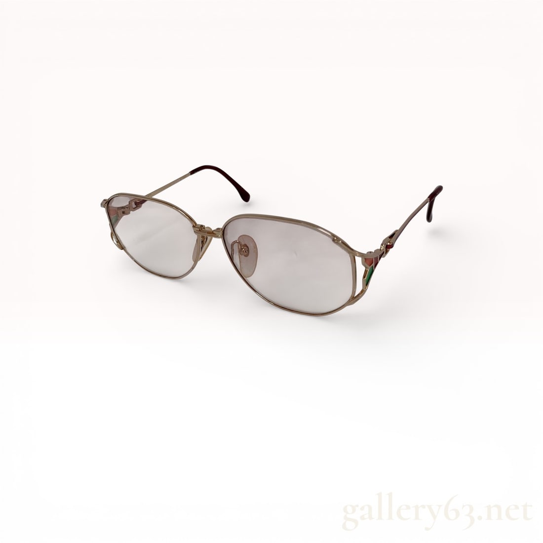 Yves Saint Laurent Gold-Tone Aviator Sunglasses with Tinted Lenses and Red/Green Temple Detail: Yves Saint Laurent Gold-Tone Aviator Sunglasses with Tinted Lenses and Red/Green Temple Detail Description: Yves Saint Laurent sunglasses featuring gold-tone metal aviator-style