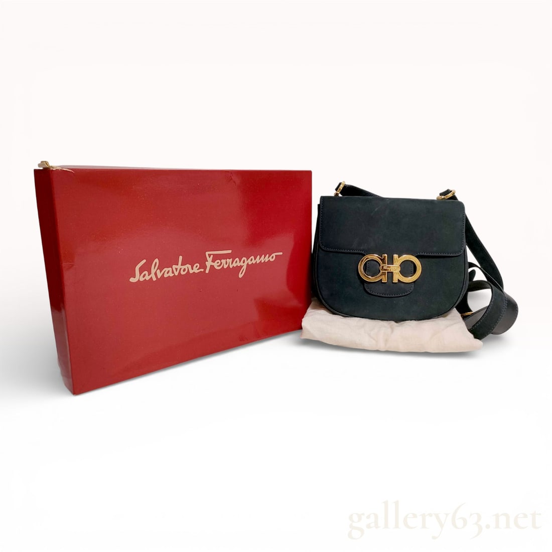 Salvatore Ferragamo Gancini Suede Shoulder Bag Black with Box and Dust Bag: Authentic Salvatore Ferragamo Gancini shoulder bag in black suede, featuring a softly structured silhouette with curved flap. The front is accented by an oversized gold tone Gancini logo clasp. The de