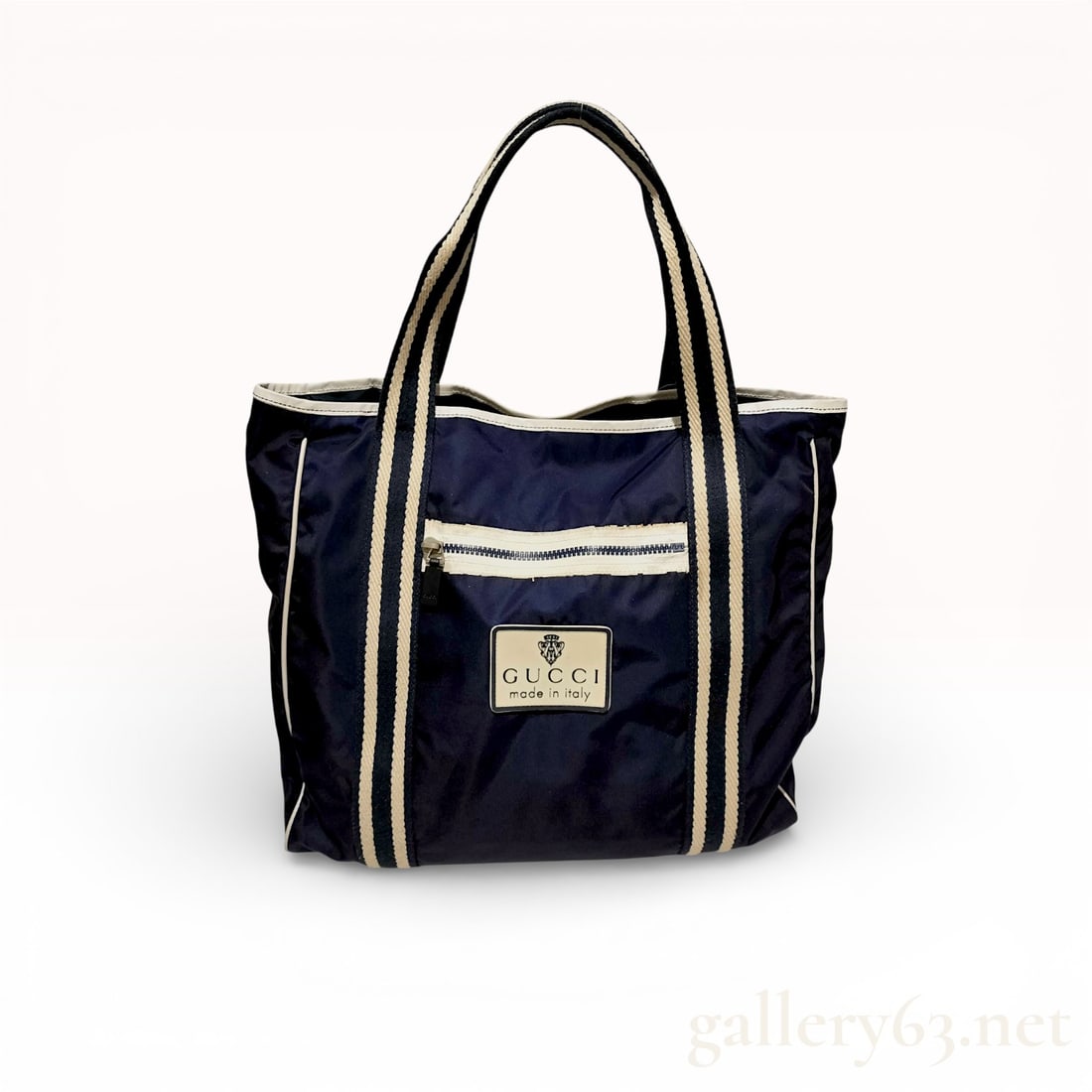 Vintage Gucci Navy Nylon Tote Bag: Authentic Gucci tote bag in navy nylon, featuring a lightweight rectangular silhouette with white contrast trim. The front is detailed with a zip pocket and Gucci made in Italy logo patch. The design