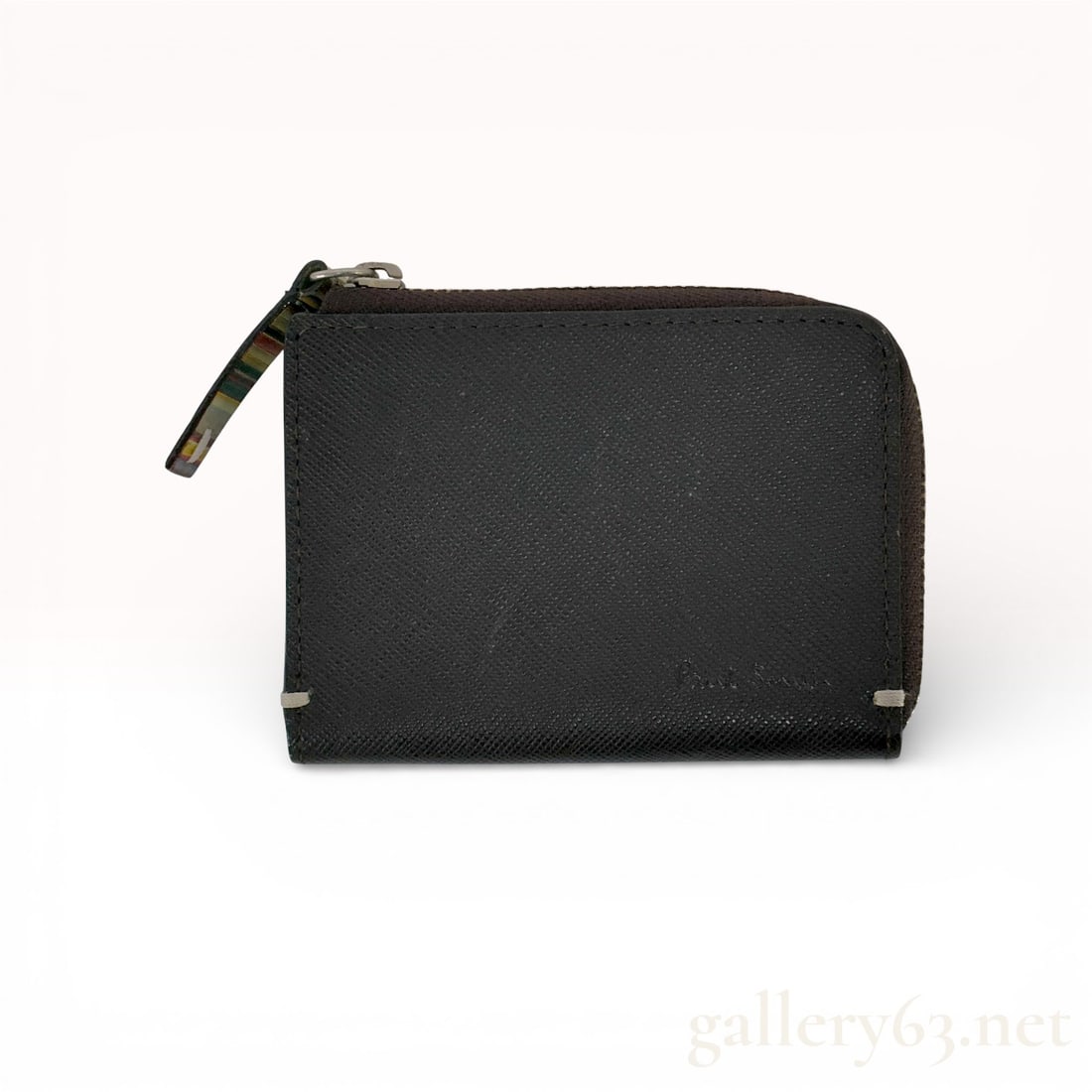 Paul Smith Black Leather Zip Coin Case with Stripe Pull: Paul Smith coin case in black textured leather featuring a zip-around closure. Rectangular case having a crosshatch-textured black leather exterior with stitched edges and small metal corner acce