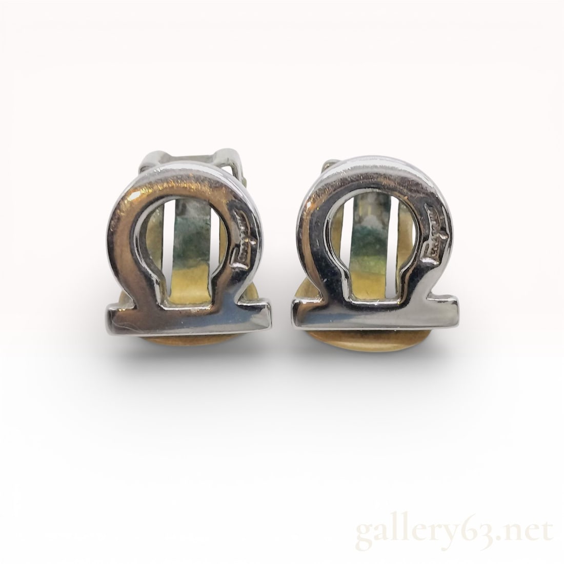 Salvatore Ferragamo Silver-Tone Gancini Logo Clip-On Earrings: Salvatore Ferragamo earrings featuring the signature Gancini logo motif in a polished silver-tone finish. Clip-on style design having sculptural curved hardware with a structured openwork form.