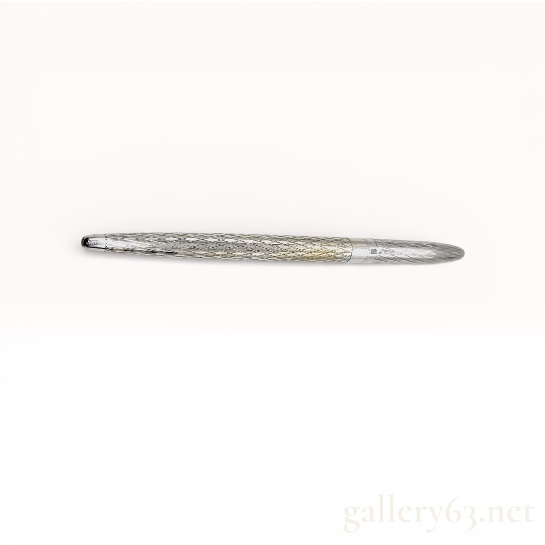 Tiffany & Co. 925 Sterling Silver Ballpoint Pen: Tiffany & Co. ballpoint pen featuring a sterling silver body. Slim cylindrical form having a textured engraved surface along the barrel. Tapered writing tip wi
