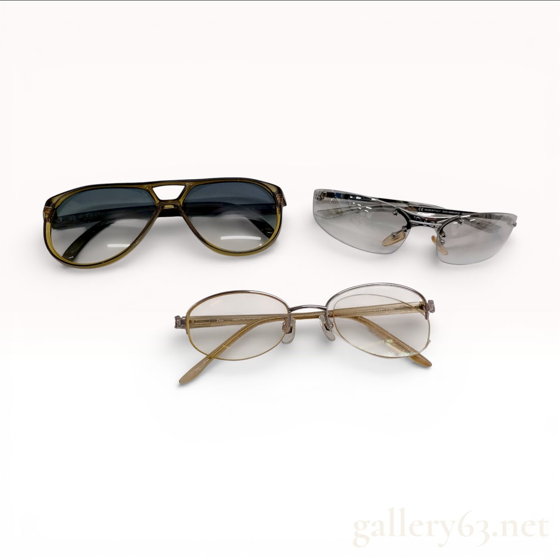 Christian Dior Sunglasses and Eyeglasses Assorted Group of Three: Christian Dior eyewear group featuring three assorted pairs of sunglasses and eyeglasses. One pair having an aviator-style frame with dark gradient lenses and a double bridge design.