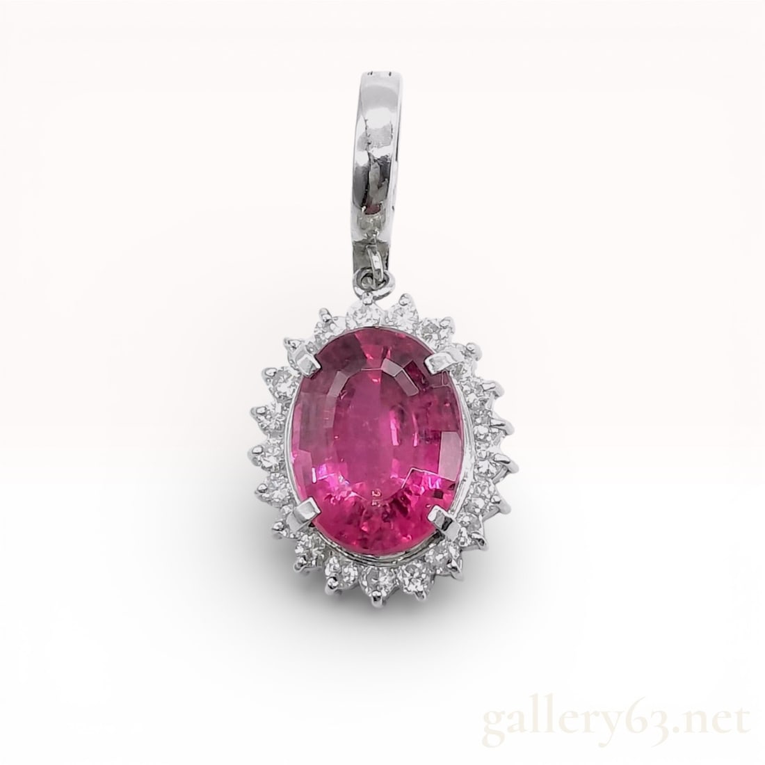 Platinum 4.54ct Pink Tourmaline .42ct Diamond Pendant 5.8 grams: Platinum pendant top featuring an oval-cut pink tourmaline weighing approximately 4.54 carats, surrounded by a halo of round brilliant-cut diamonds totaling approximately 0.42 carats. Constructed in P