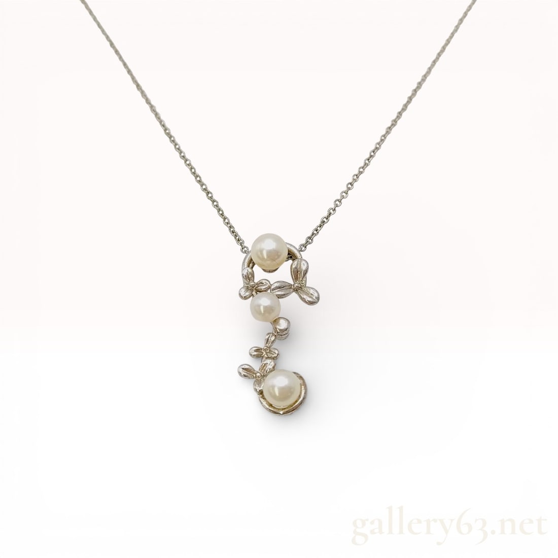 Tasaki Pearl Pendant Necklace 4.3–5.3mm in Sterling Silver, 3.5g: \Tasaki necklace featuring a delicate sterling silver chain suspending a pearl pendant design accented with small leaf-like motifs. Set with lustrous round pearls measuring approximately 4.3–5.3mm i