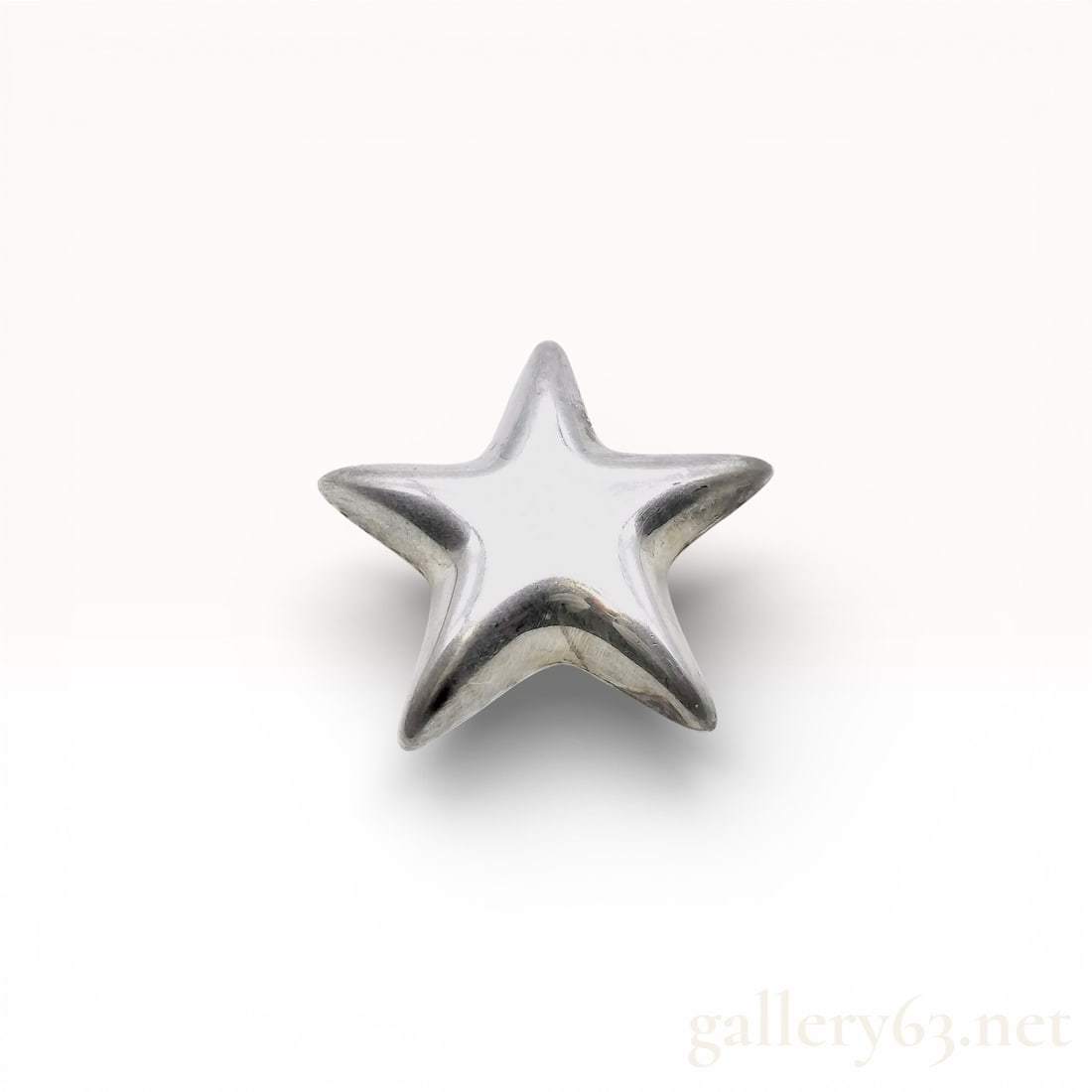 Tiffany & Co. Sterling Silver Puffy Star Brooch: This vintage Tiffany & Co. brooch is designed as a five-pointed puffed star, featuring a domed, polished front and a flat reverse. The piece is crafted in sterling silver and is equipped with a pin