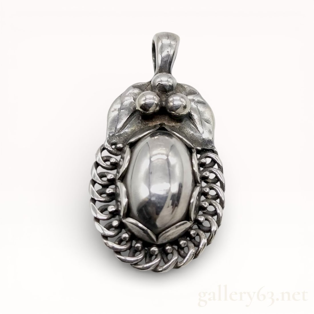 Georg Jensen .925 Silver Nut 1992 Pendant With Box: Authentic Georg Jensen Pendant. Sculptural silver form of organic nut motif, featuring a polished central element framed by a twisted rope-style surround. Design including layered contours and rounded