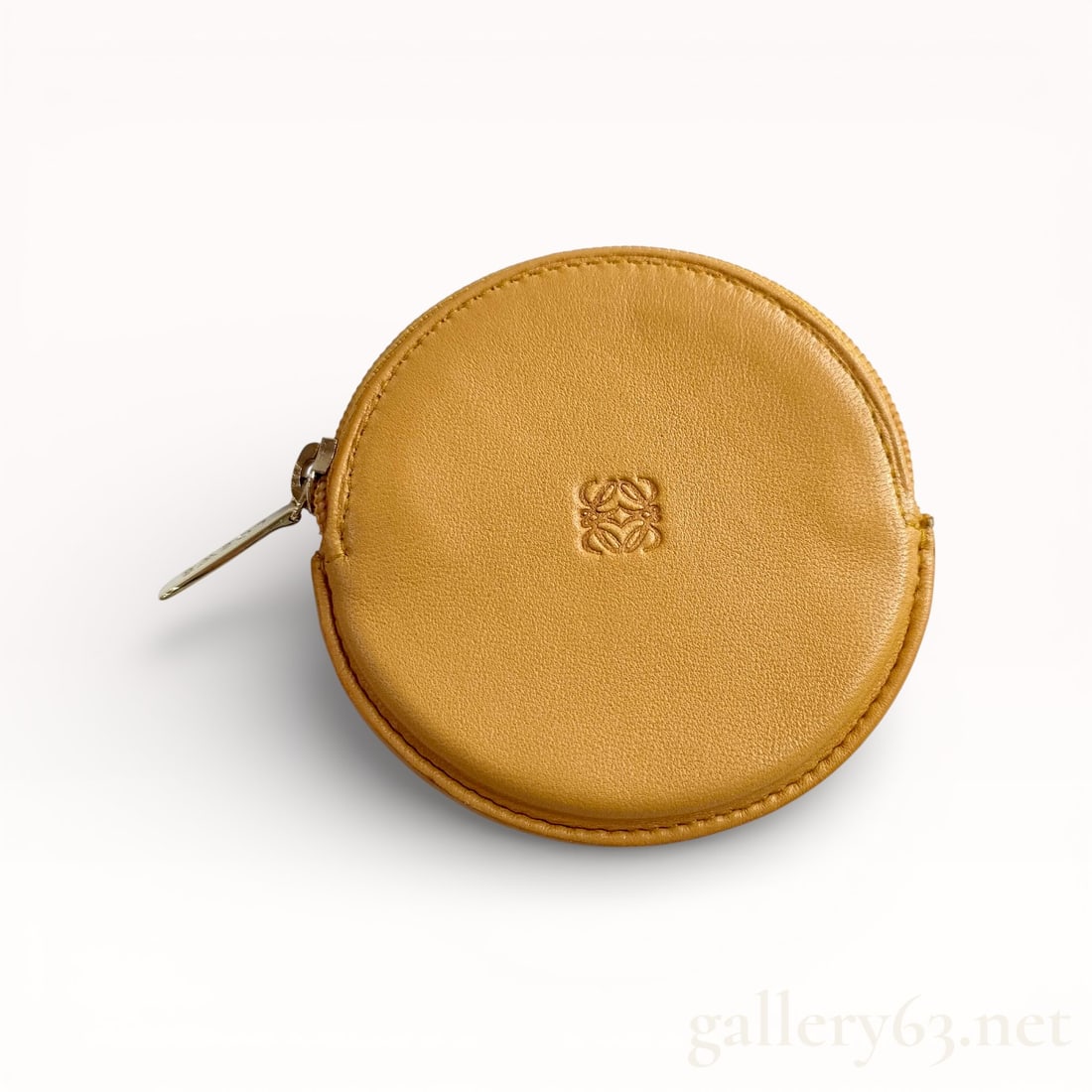 Loewe Anagram Round Leather Coin Case with Box: Authentic Loewe coin case featuring a round silhouette crafted in yellow leather with a smooth exterior finish. Front embossed with the Loewe anagram logo at center. Zip-around closure secured by a me