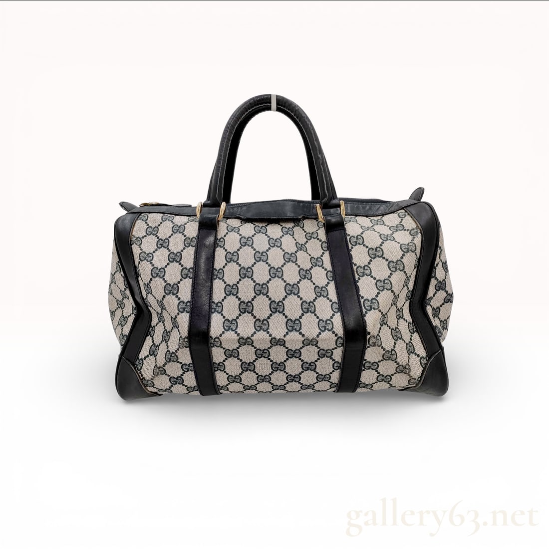 Vintage Gucci GG Canvas Boston Bag: This Gucci GG Canvas Boston bag is constructed from monogrammed GG canvas in a grey and navy colorway. The exterior features dark navy leather trim including corner reinforcements and piping with dual