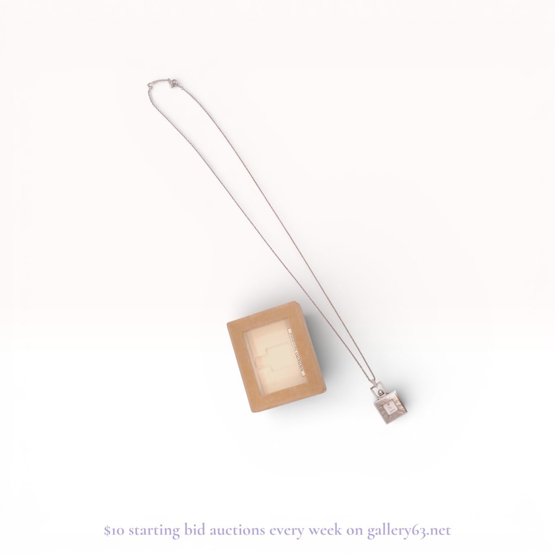 Mikimoto International Silver-Toned Pendant Watch with Cultured Pearl: A Mikimoto International pendant watch featuring a square silver-toned case and a white dial with the brand's crown logo. The watch is set within an outer square frame that is engraved with Roman nume