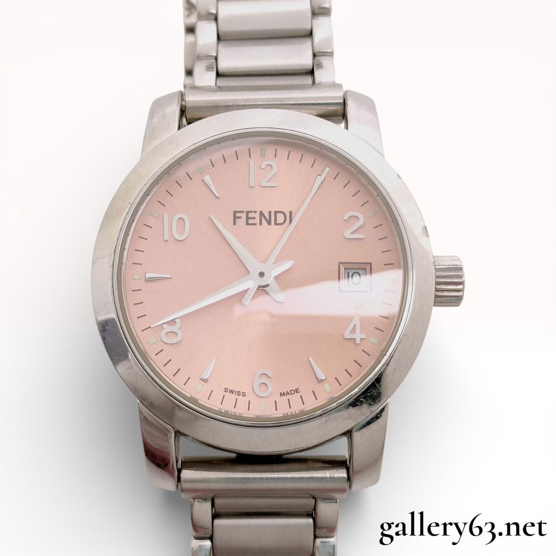 Fendi 2100L Stainless Steel Ladies Watch with Salmon Dial: Brand: Fendi. Model: 2100L. Reference Number: 023-764. Movement: Swiss quartz. Case: Stainless steel with signed F logo crown. Dial: Salmon pink sunray finish featuring Arabic numeral and baton hour m