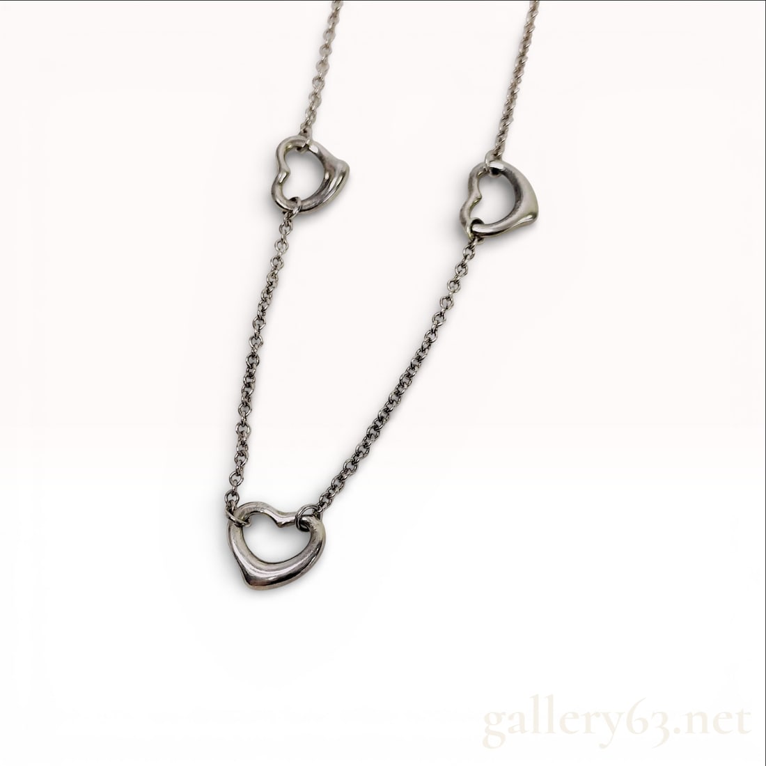 Sterling Silver Station Necklace, Tiffany & Co. Elsa Peretti Triple Open Heart: This authentic Tiffany & Co. sterling silver station necklace is part of the iconic Elsa Peretti collection. The piece features a fine cable link chain accented by three integrated open heart motifs.