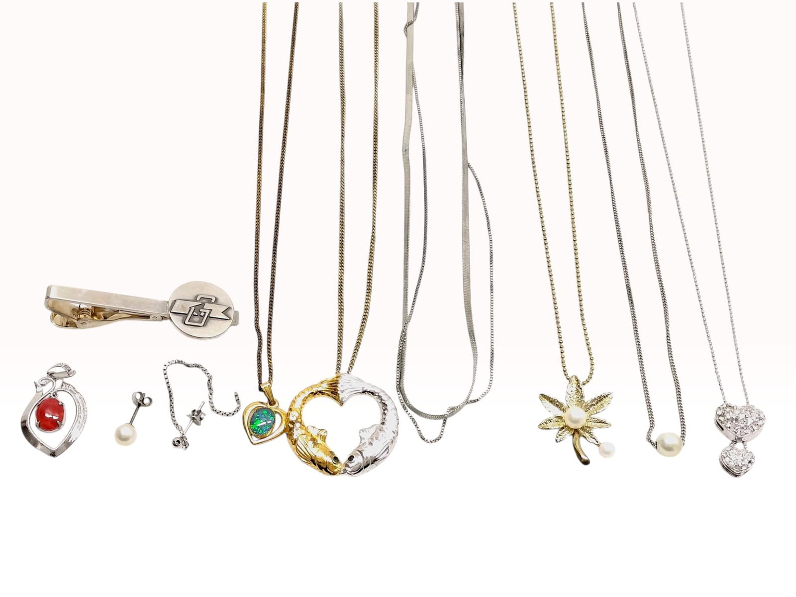Sterling Silver, Silver-Toned and Gilt Jewelry Lot Featuring Heart Pendants and Anniversary Tie Clip: This mixed jewelry lot consists of an assortment of necklaces and accessories. It includes a silver-toned tie bar featuring a Japanese inscription for a Founding 25th Anniversary and a silver-toned op