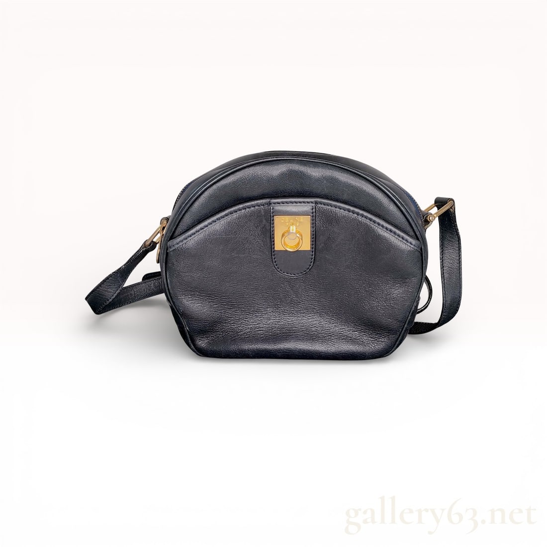 Celine Vintage Ring-Clasp Front Pocket Crossbody Bag Black Leather: This authentic vintage Celine crossbody bag is crafted from smooth black leather, featuring a classic rounded dome silhouette. The exterior is accented with a functional front flap pocket secured by a