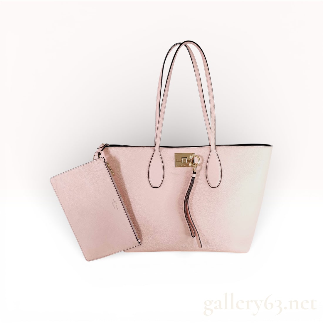 Salvatore Ferragamo Studio Tote Bag, Pebbled Calfskin Leather, Blush Pink: This Salvatore Ferragamo Studio Tote Bag is constructed from premium pebbled calfskin leather in a blush pink color. The bag features gold-tone hardware, including a signature Gancini flip-lock closur