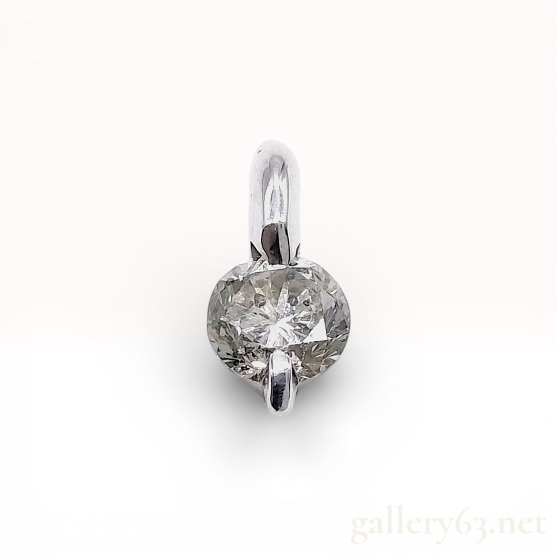 18K White Gold Diamond Solitaire Slider Pendant: A contemporary solitaire slider pendant crafted in 18K white gold featuring one round brilliant cut diamond. The diamond is held in a minimalist two-prong setting with an integrated bail design that a