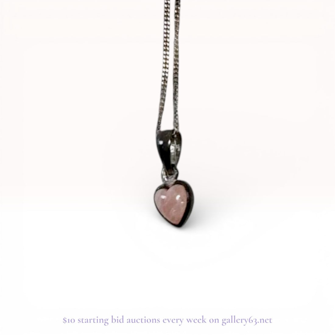 Sterling Silver UnoAerre Curb Link Necklace with Rose Quartz Heart Pendant: This sterling silver necklace features a fine curb link chain paired with a heart-shaped pendant. The pendant showcases a single bezel-set, heart-shaped cabochon rose quartz with a soft translucent