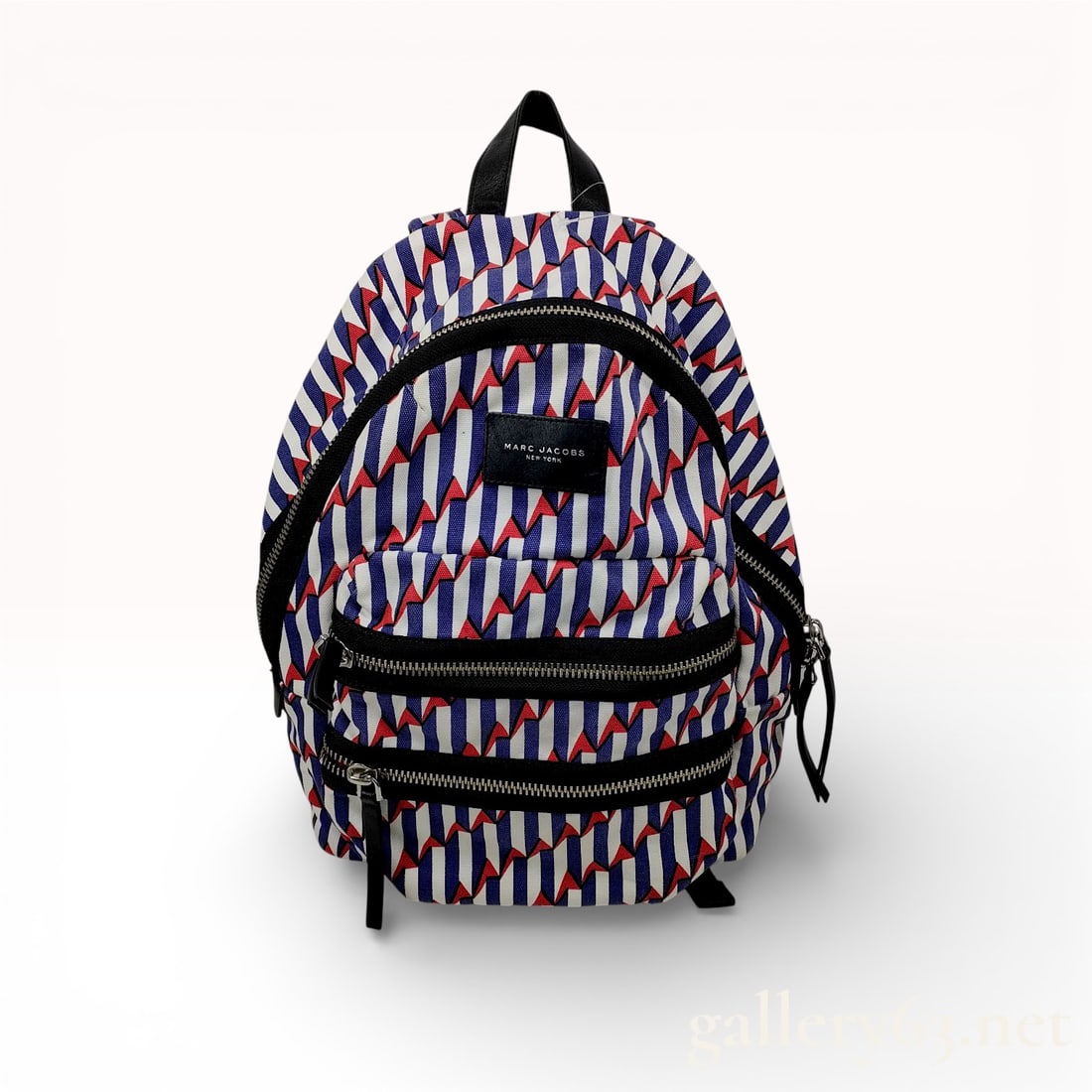 Marc Jacobs Arrow Head Mini Biker Canvas Backpack Multicolor: This Marc Jacobs Arrow Head Mini Biker backpack is constructed from durable printed canvas featuring a geometric zigzag pattern in shades of blue, red, and white. The design includes black leather tri