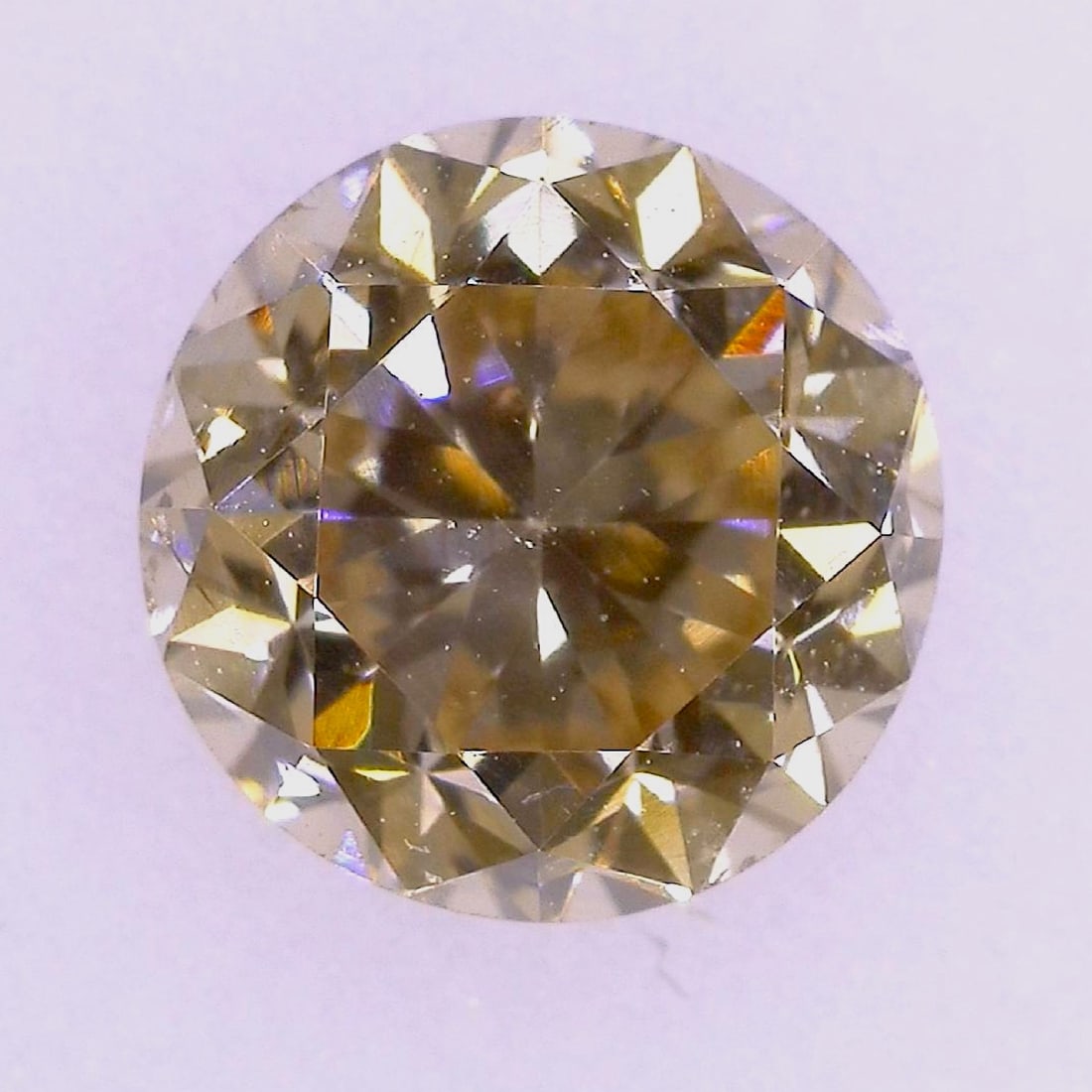 Diamond, Round Brilliant Cut, 5.64 - 5.69 mm: This natural loose diamond features a round brilliant cut and displays a Fancy Light Brown color of natural origin. The stone is graded with SI-1 clarity and is accompanied by a gemological report