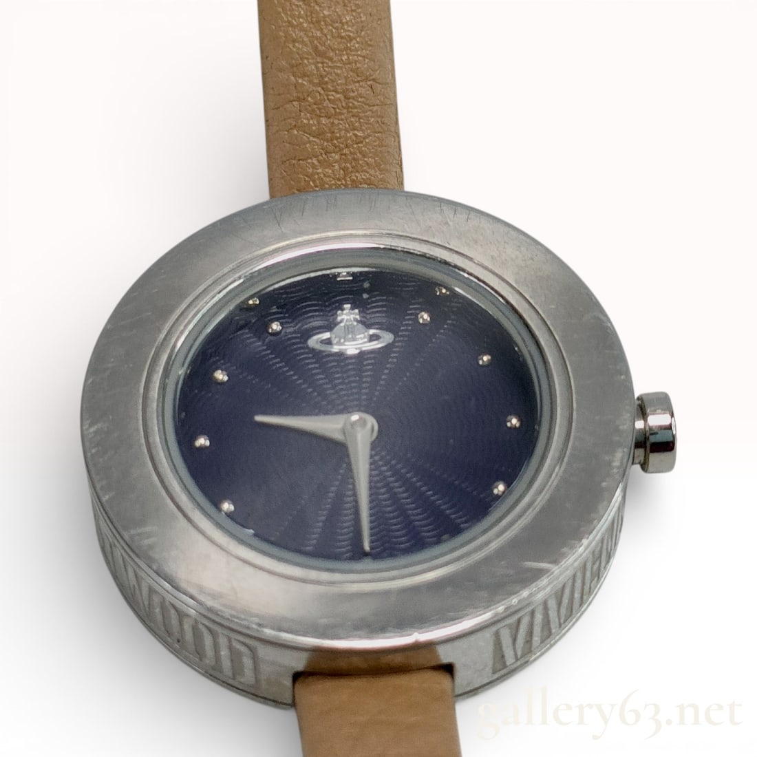 Vivienne Westwood Edge Ladies' Wristwatch with Navy Sunburst Dial: Vivienne Westwood, Edge model, reference VV097NVTN PC. This timepiece features a Swiss quartz movement. The circular stainless steel case is designed with a wide bezel and the brand name engraved alon