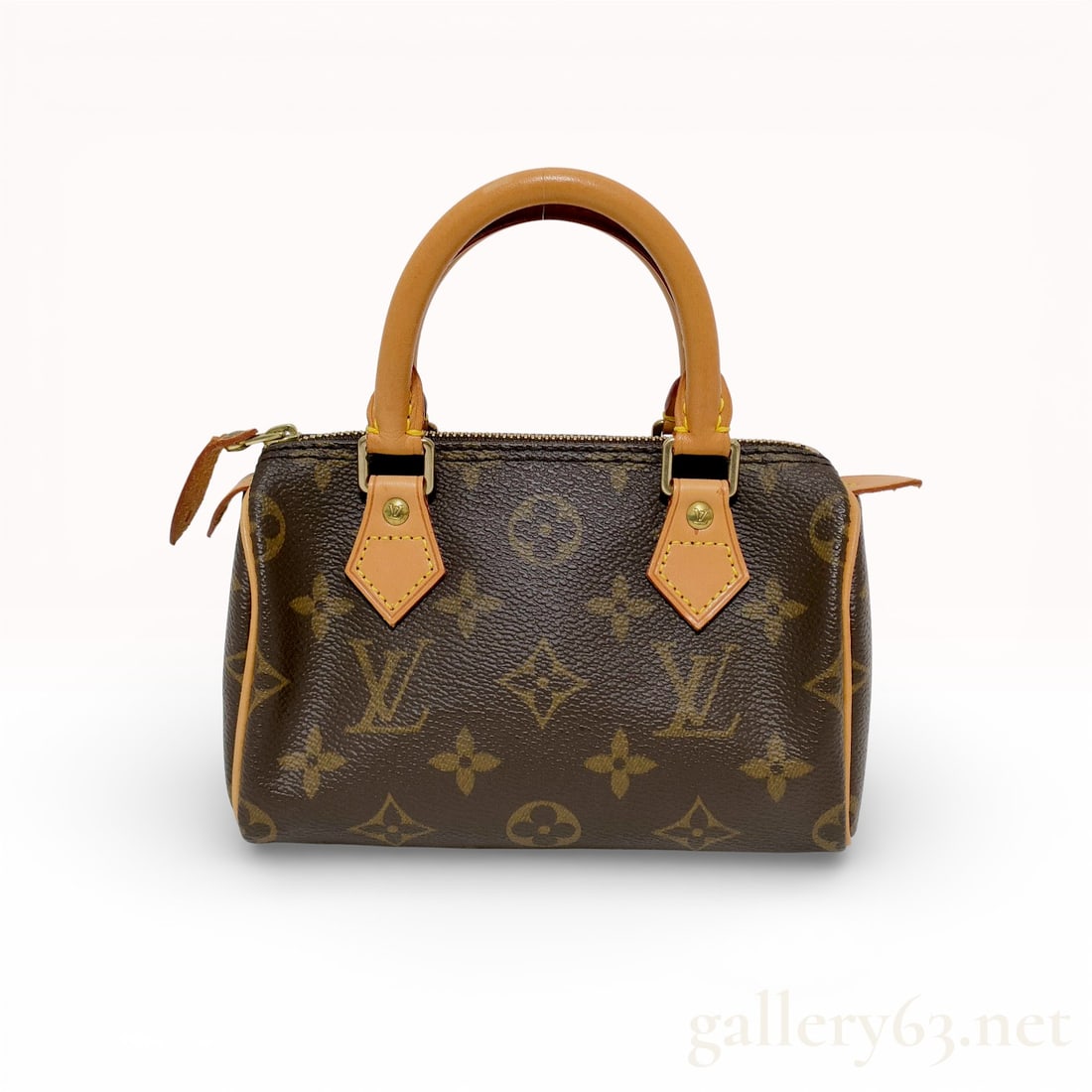 Louis Vuitton Mini HL Speedy Monogram Canvas Brown: This Louis Vuitton Mini HL Speedy is a vintage miniature iteration of the house's most iconic travel bag. It is crafted from signature Monogram coated canvas with natural vachetta cowhide leather trim