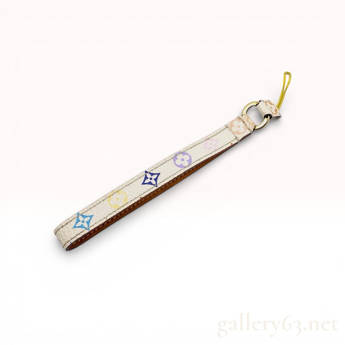 Louis Vuitton Monogram Multicolore White Canvas Wristlet Strap: This Louis Vuitton accessory is a versatile piece from the iconic collaboration with Japanese artist Takashi Murakami. Crafted from white Monogram Multicolore coated canvas, the strap features the sig