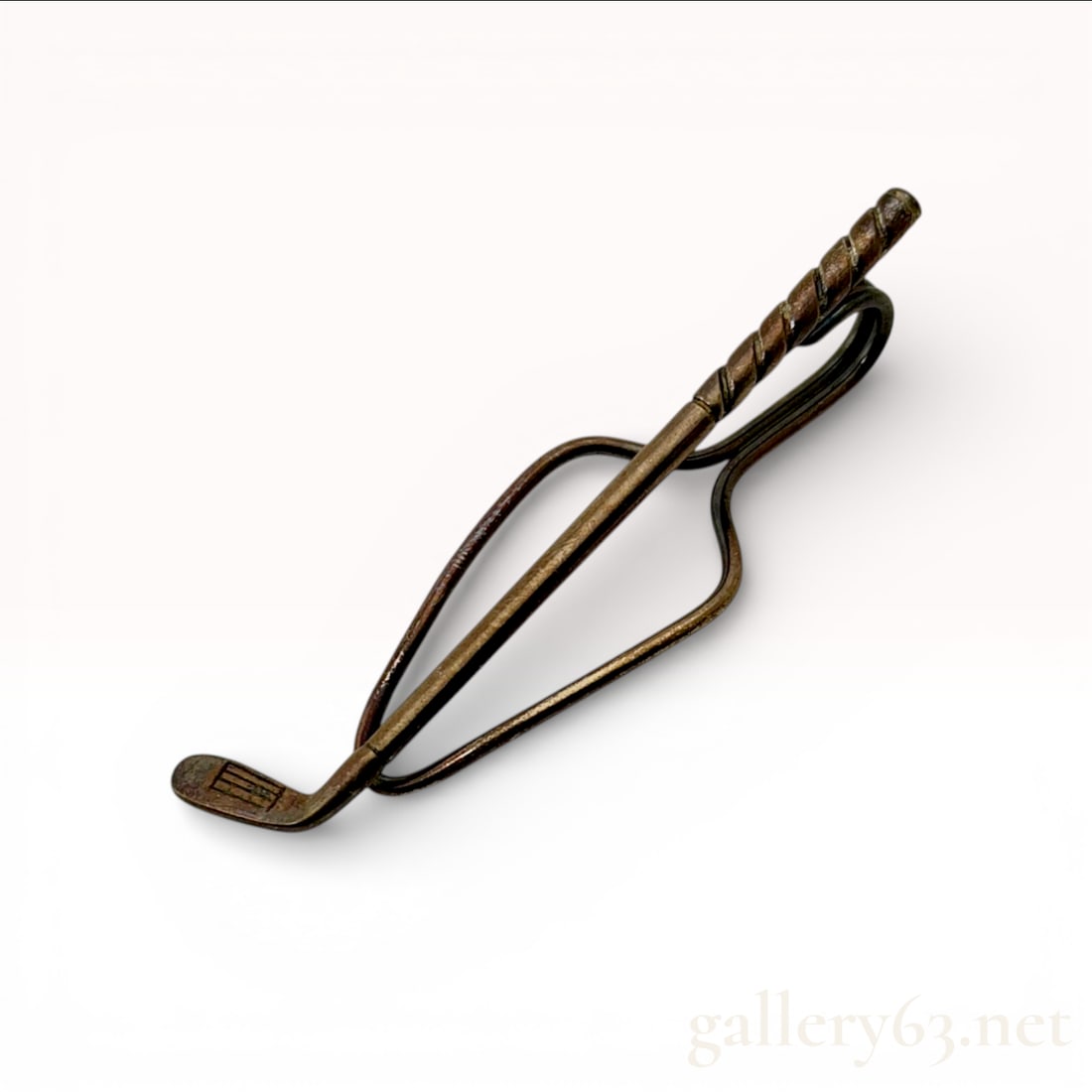 Tiffany and Co. Golf Club Tie Clip, Sterling Silver, Vintage: This vintage Tiffany and Co. men's accessory is crafted from sterling silver in the form of a golf club. The piece features a stylized design with a textured, spiral-wrapped grip and a detailed club h