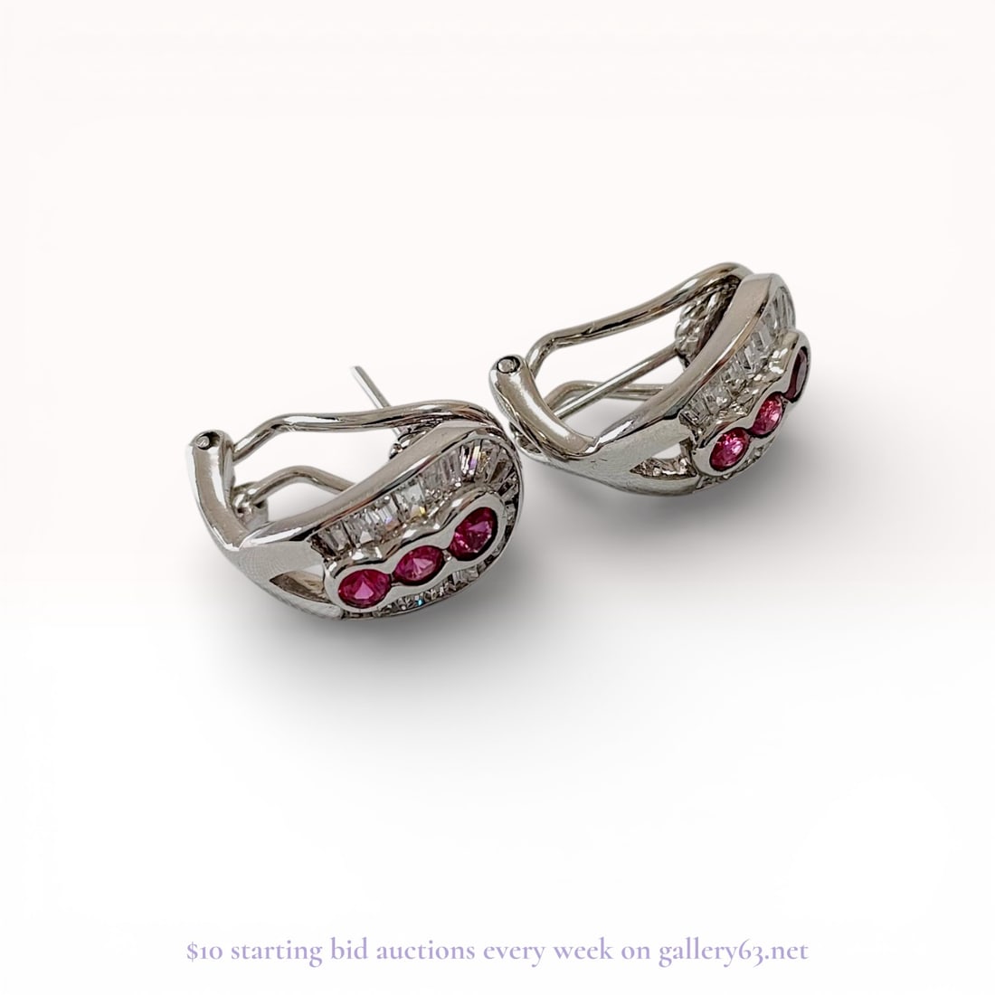 Sterling Silver Omega-Back Half-Hoop Earrings with Pink and Clear Stones: A matched pair of contemporary, contoured half-hoop earrings crafted in sterling silver. Each earring features a central row of three round-cut vibrant pink stones, flanked by an inner and outer borde