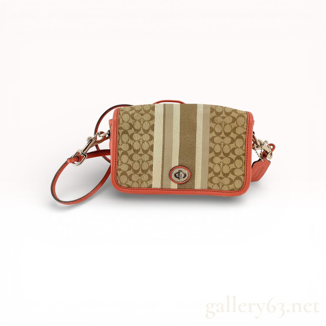 Coach Legacy Signature Stripe Penny Crossbody Bag, Canvas and Leather, Khaki and Coral: This Coach Legacy Penny crossbody bag is crafted from signature jacquard canvas in a khaki and brown pattern, featuring distinctive vertical stripes in cream and tan. The bag is accented with coral-co