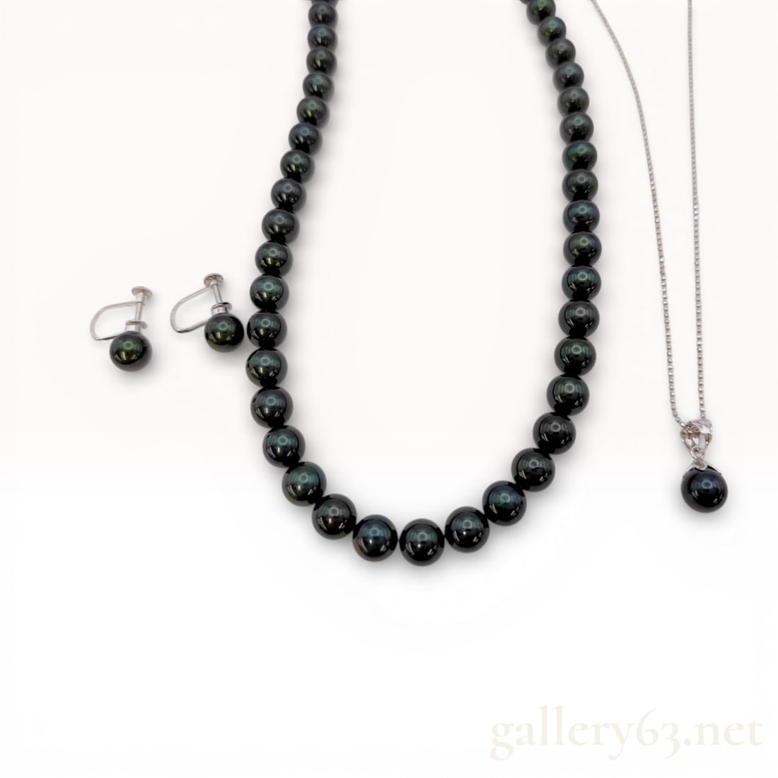 Sterling Silver Graduated and Pendant Necklace Suite with Black Cultured Pearls: A four-piece jewelry suite featuring black cultured pearls exhibiting peacock overtones of green, rose, and purple. The suite includes a single-strand graduated necklace of approximately 50 to 52 indi