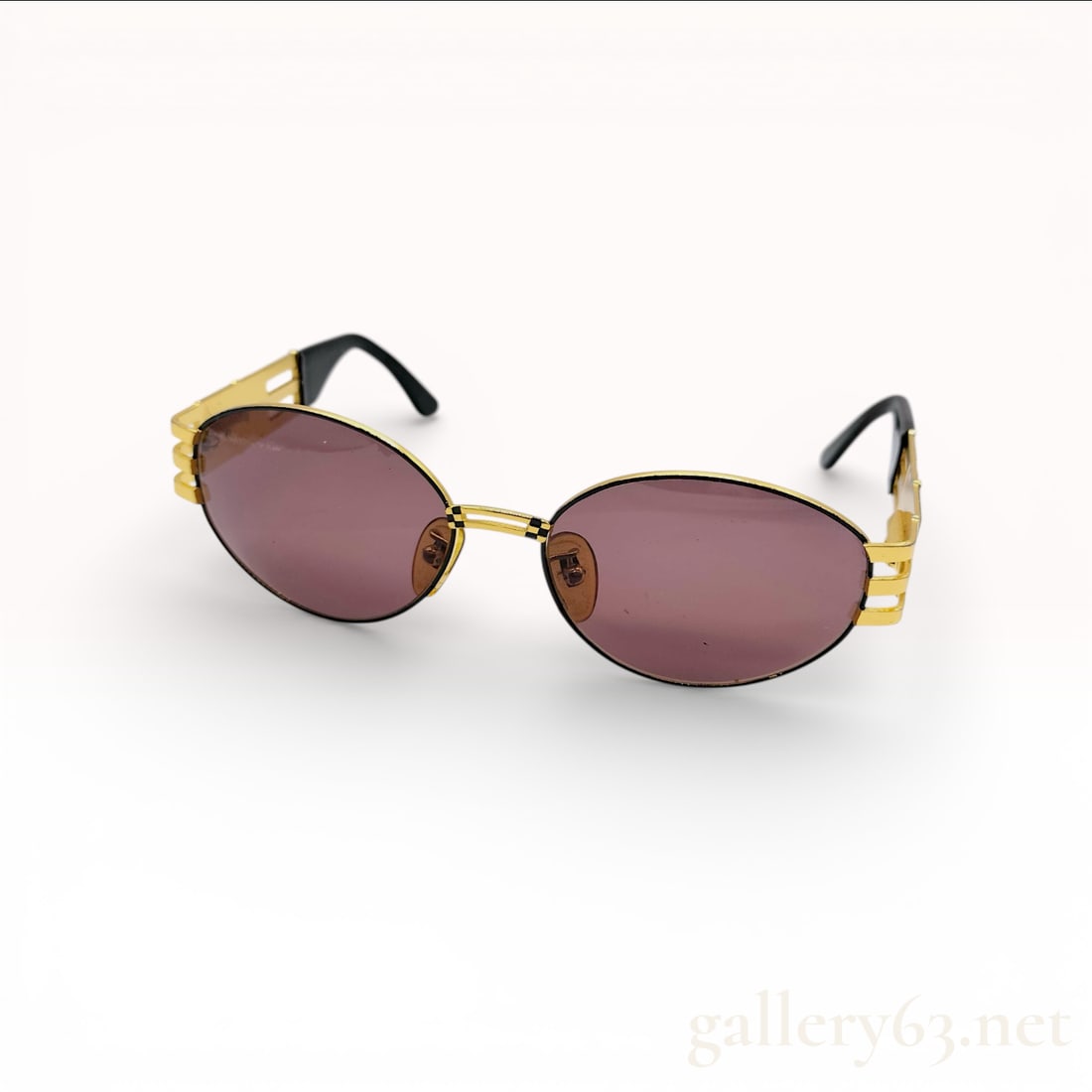 Fendi Vintage SL 7027 Gold-Tone Checkerboard Oval Sunglasses: A pair of vintage Fendi oval-frame sunglasses, model SL 7027 COL. 101, featuring a luxurious gold-tone metal construction. The design is highlighted by triple-bar temples that transition into decorati