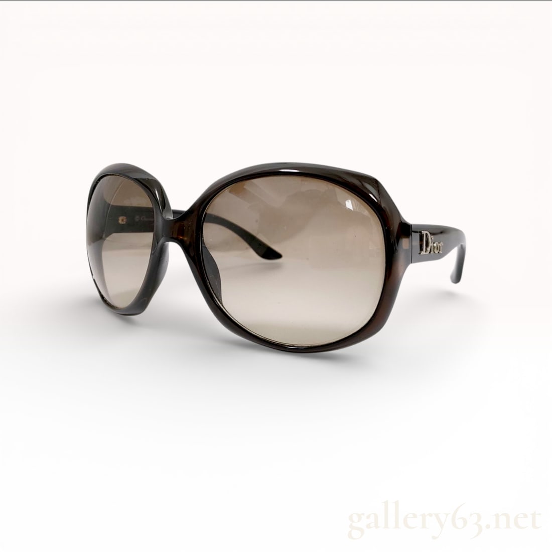 Christian Dior Glossy 1 Sunglasses, Havana Optyl Resin: A pair of Christian Dior Glossy 1 oversized sunglasses. These designer frames are crafted from high-quality dark translucent brown Havana Optyl resin and feature gradient-tinted lenses. The temples ar