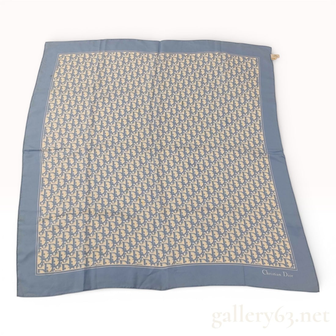 Christian Dior Silk Oblique Monogram Square Scarf: A vintage Christian Dior square silk scarf featuring the iconic all-over Dior Oblique monogram pattern. The design is rendered in light blue against an ivory background, framed by a solid light blue b