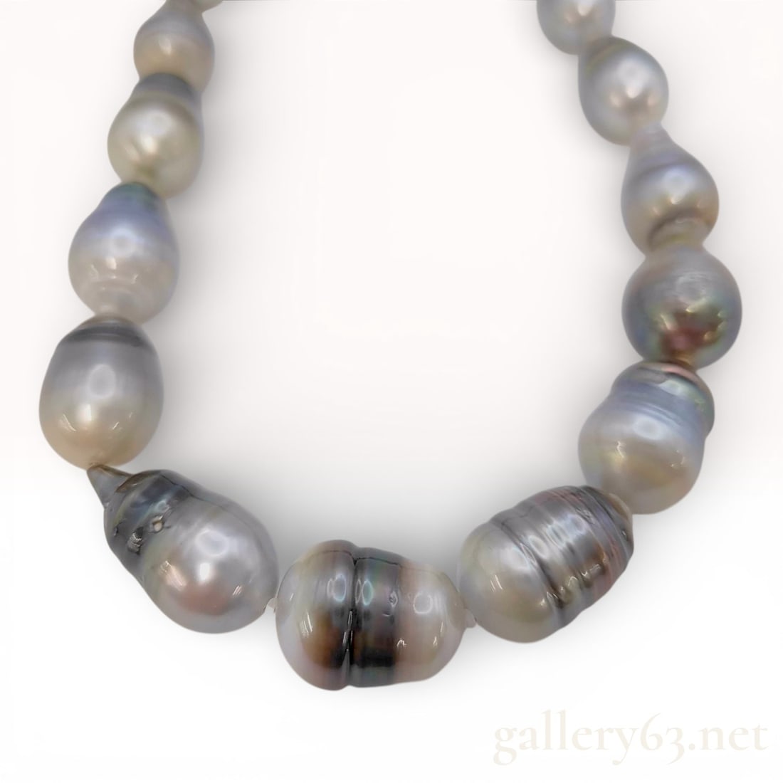 Silver Tahitian Cultured Pearl Graduated Baroque Necklace: This necklace is composed of a single strand of graduated Tahitian cultured pearls. The pearls are of baroque and circled shapes, exhibiting a range of natural body colors including silver, light gray