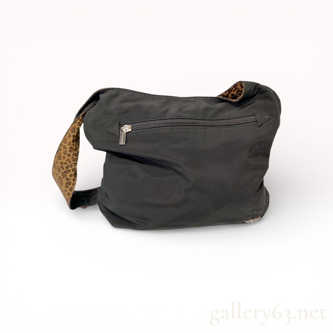 Bottega Veneta Nylon Leopard Print Hobo Bag Black: This Bottega Veneta hobo-style shoulder bag is constructed from black nylon canvas. The design features a single wide shoulder strap with a contrasting leopard print fabric on the reverse side. The ex