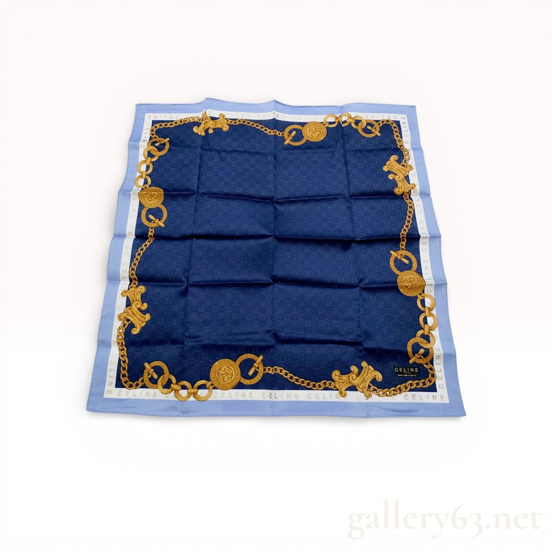 Celine Cotton Square Scarf with Triomphe Monogram and Chain Border: This vintage square scarf by Celine Paris is crafted from 100% cotton. The design features a navy blue field with a tonal, all-over Triomphe monogram pattern. The center is framed by a decorative bord