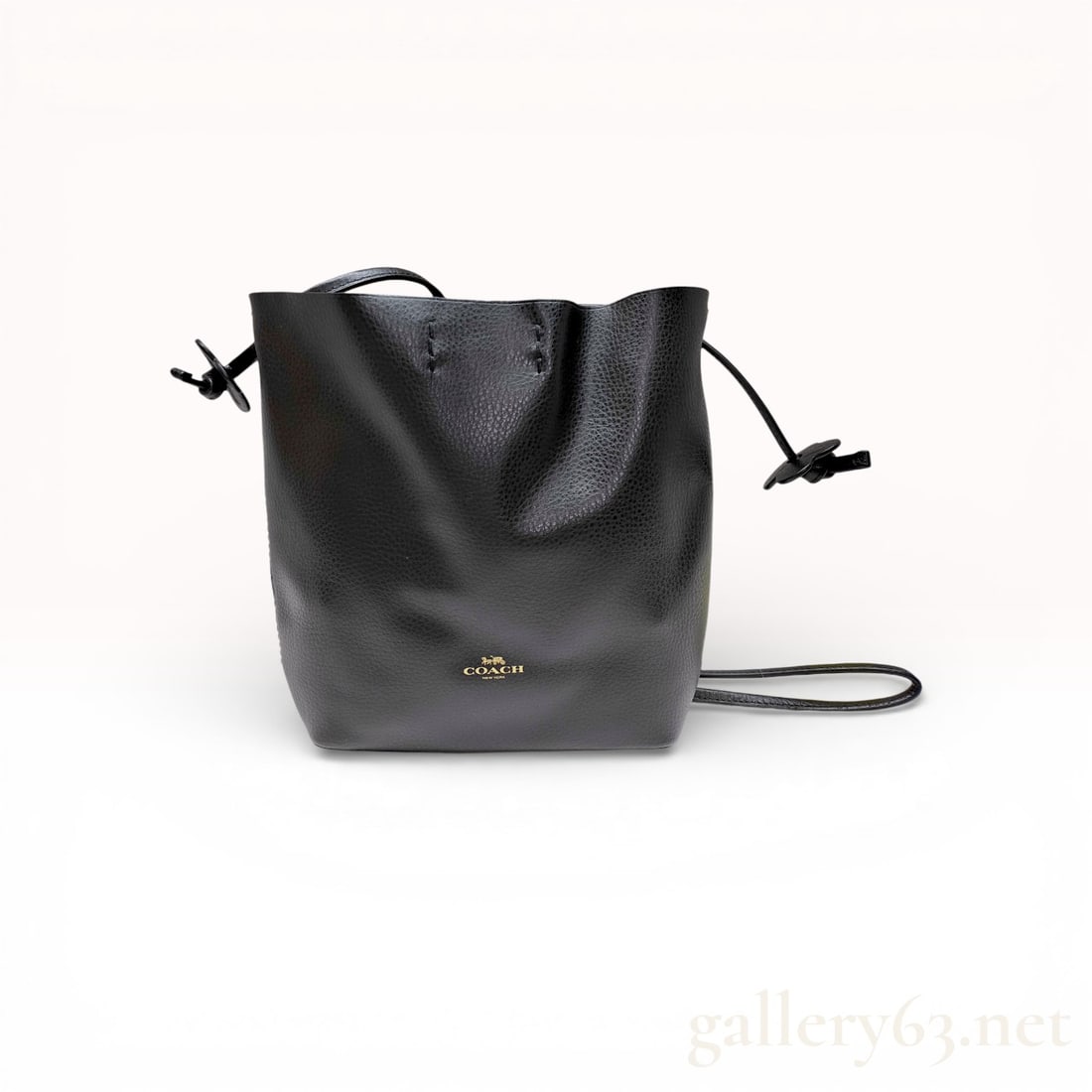 Coach Derby Small Drawstring Bucket Bag, Pebbled Leather, Black: This Coach Derby small drawstring bucket bag is crafted from black pebbled leather with a contrasting burgundy sueded interior. The exterior features a gold-stamped Coach New York horse and carriage l