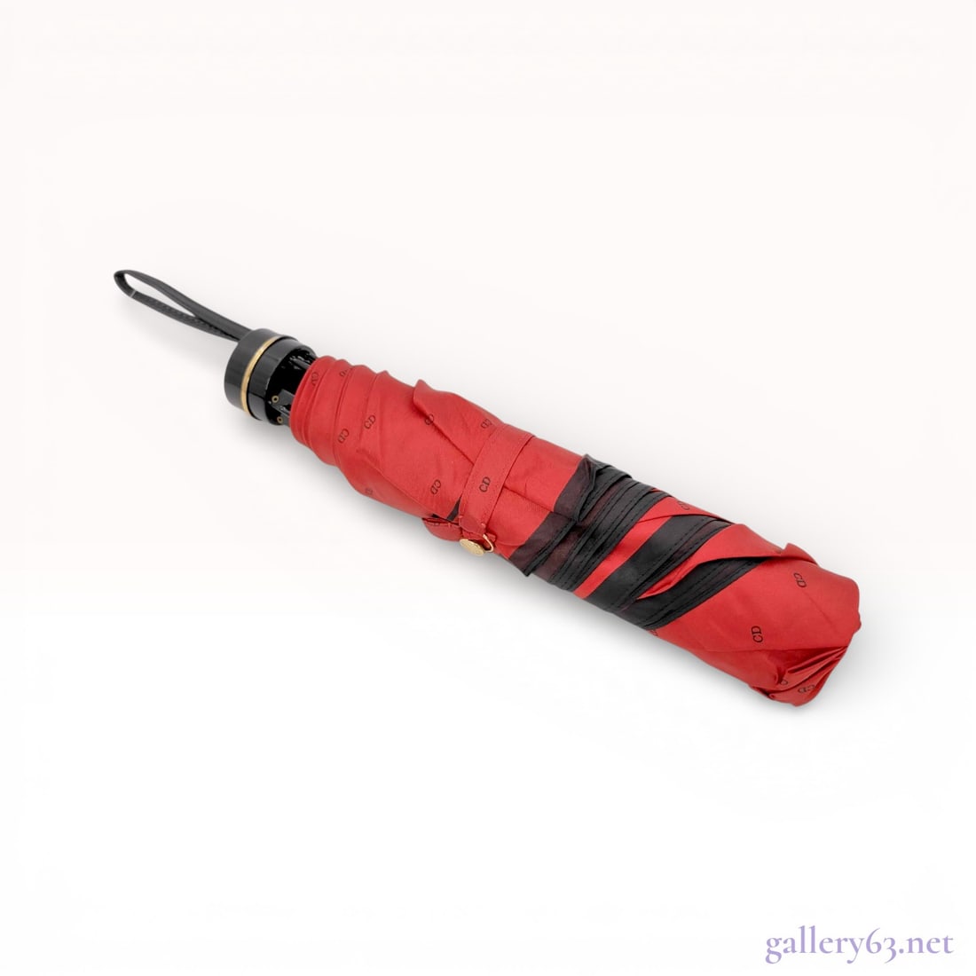 Christian Dior Monogram Folding Umbrella, Red and Black: Christian Dior folding telescopic umbrella featuring a red synthetic fabric canopy with an all-over repeating black CD monogram print and a thin black border stripe near the edge. The piece is designe