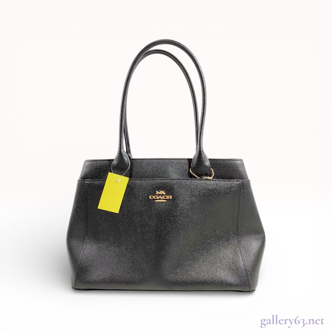 Coach Casey Tote in Black Crossgrain Leather: This Coach Casey tote is crafted from durable black crossgrain leather, featuring a structured silhouette. The exterior is adorned with the signature gold-tone Horse and Carriage metal logo and includ
