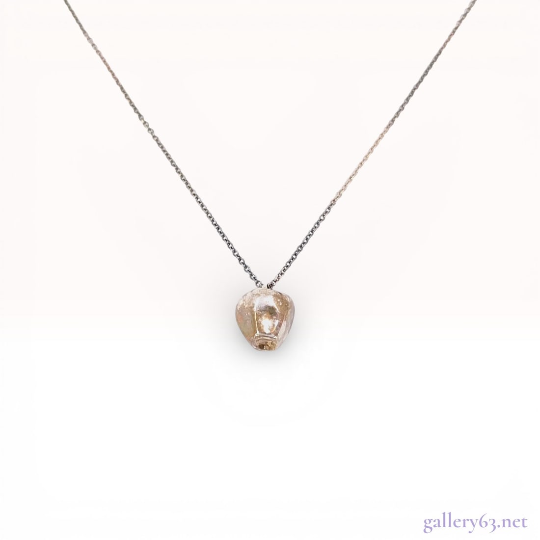 Sterling Silver Tiffany & Co. Elsa Peretti Teardrop Pendant Necklace: A sterling silver pendant necklace designed by Elsa Peretti for Tiffany & Co. The jewelry features a fine cable link chain supporting a small, sculptural pendant in an organic teardrop or bud