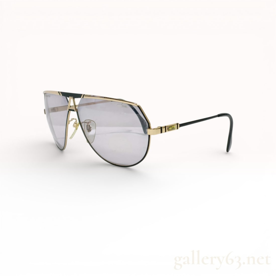 Cazal MOD 953 Gold-Tone Geometric Aviator Sunglasses: These vintage Cazal sunglasses, model MOD 953, color 302, feature a bold, oversized geometric aviator shield design. Crafted in West Germany, the gold-toned metal frame is accented with black enamel s