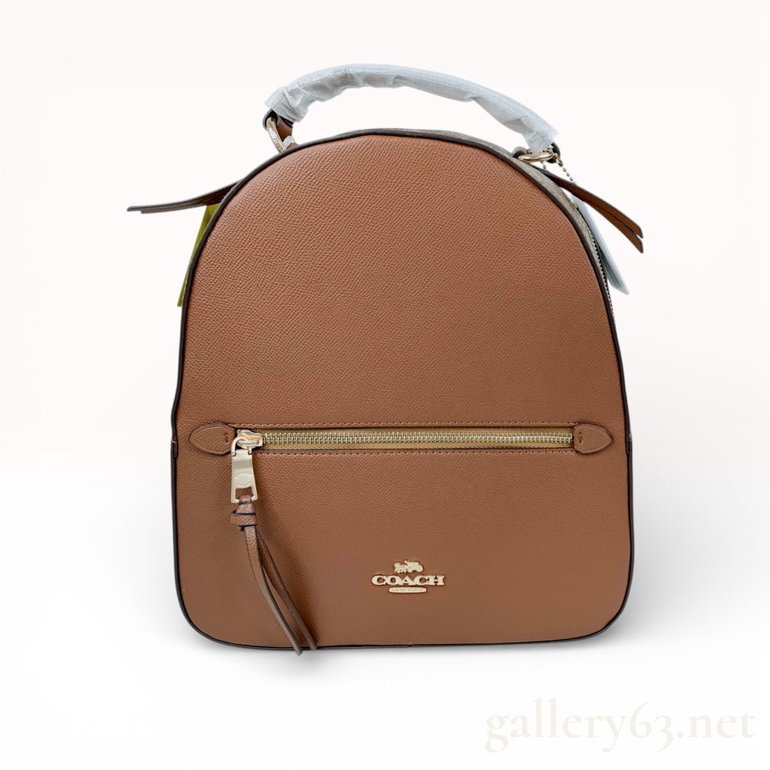 Coach Jordyn Backpack in Signature Canvas and Leather, Khaki/Saddle: This Coach Jordyn backpack is crafted from a combination of the brand's signature coated canvas and durable crossgrain leather in a saddle brown hue. The design features a structured silhouette with a